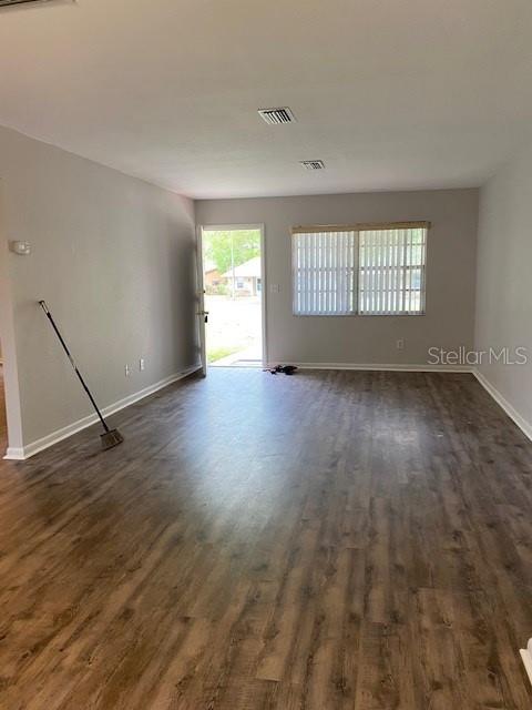 8402 Southwest 101st Place Road Ocala, FL 34481 - Photo 3 of 8 an empty room with wooden floor and windows