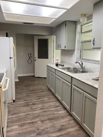 a kitchen with a sink stove and cabinets