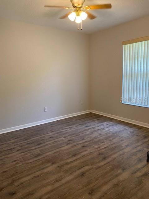 8402 Southwest 101st Place Road Ocala, FL 34481 - Photo 7 of 8 a view of an empty room with wooden floor and a window