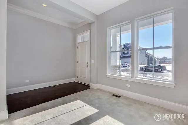 a view of an empty room with windows