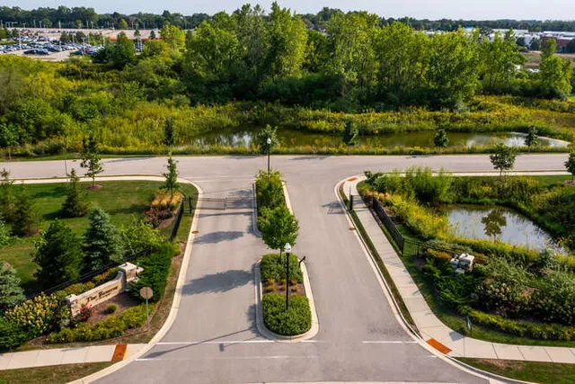 a kitchen with kitchen island granite countertop a sink cabinets and stainless steel appliances