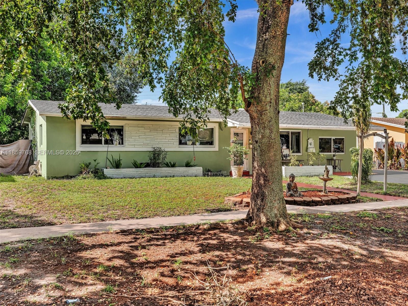 6472 Johnson Street Hollywood, FL 33024 - Photo 46 of 59 a front view of a house with a yard