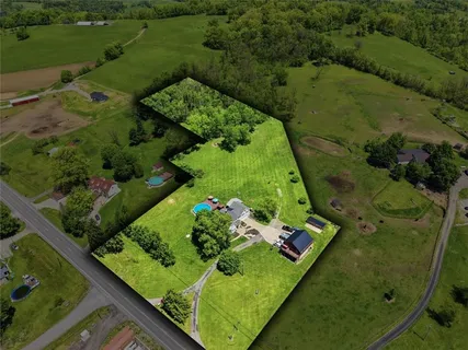 an aerial view of a residential houses with outdoor space