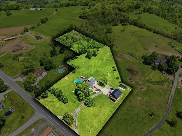 an aerial view of a residential houses with outdoor space