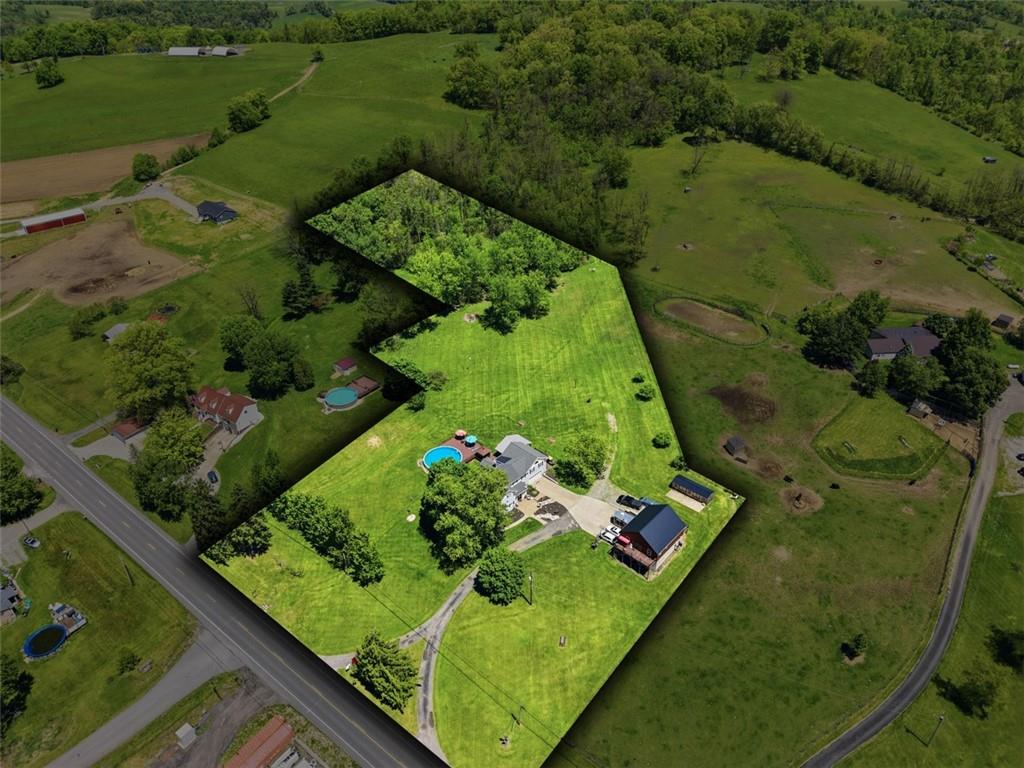 an aerial view of a residential houses with outdoor space