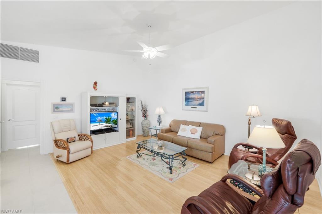 3609 Exuma Way Naples, FL 34119 - Photo 11 of 43 a living room with furniture and a fireplace