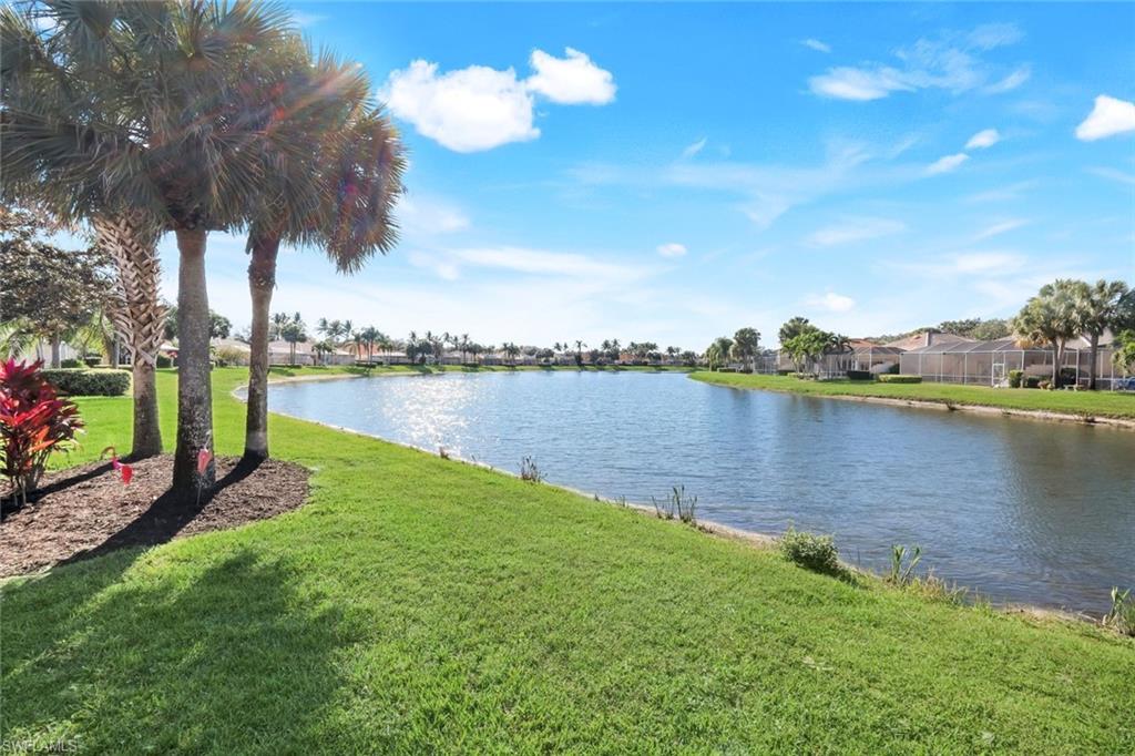 3609 Exuma Way Naples, FL 34119 - Photo 2 of 43 a view of a lake with houses in the back