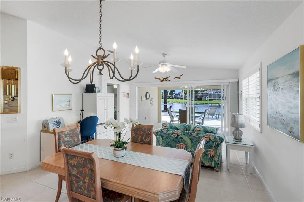 3609 Exuma Way Naples, FL 34119 - Photo 21 of 43 a view of a dining room with furniture a chandelier and wooden floor