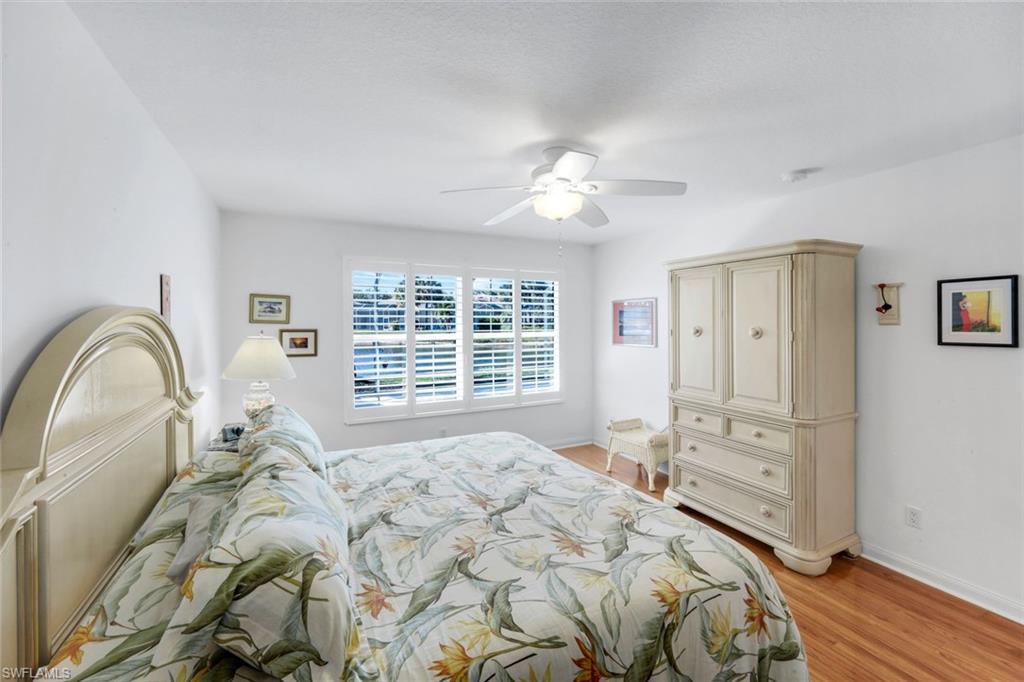 3609 Exuma Way Naples, FL 34119 - Photo 23 of 43 a bedroom with a bed and a chandelier