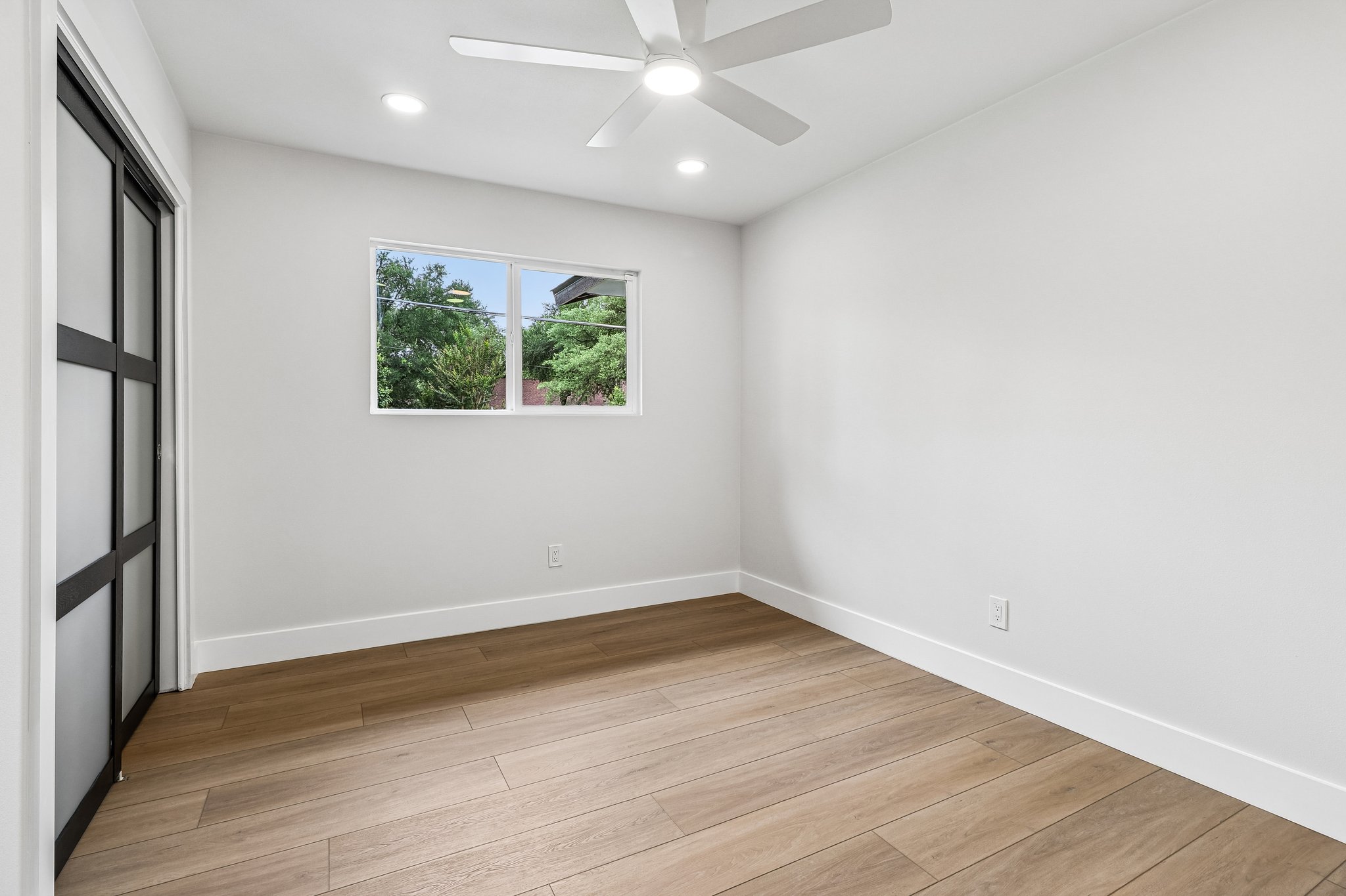 11809 Charing Cross Road Austin, TX 78759 - Photo 21 of 34 Well-lit sleeping quarters feature sleek flooring and ample natural light.