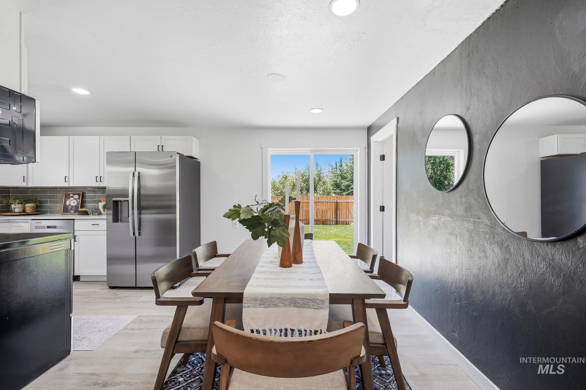 2152 Artesian Road Eagle, ID 83616 - Photo 14 of 50 Open-concept dining area featuring a textured accent wall and light wood-finish flooring