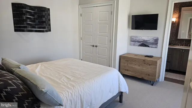 a bedroom with a bed and a couch