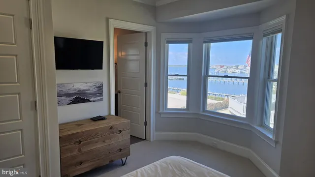 a bedroom with a large bed and a window