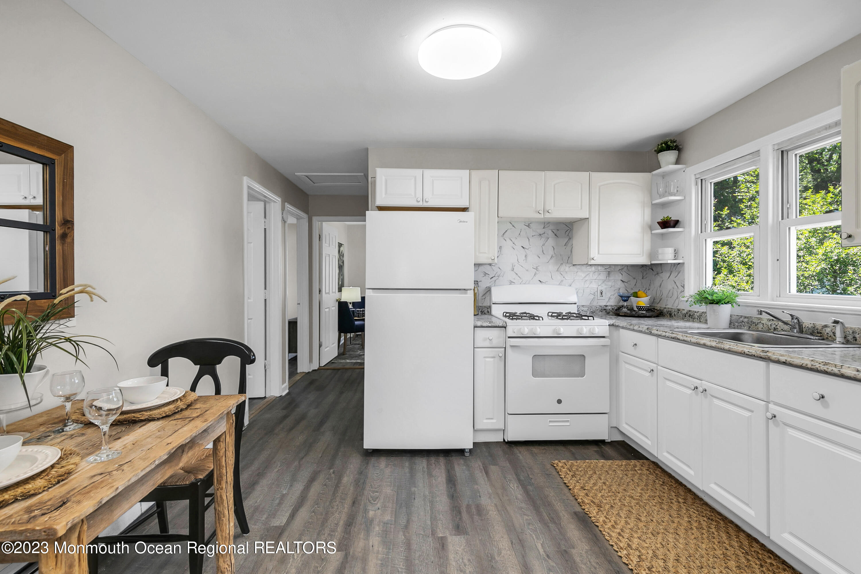 197 Raritan Street Keyport, NJ 07735 - Photo 11 of 28 a kitchen with granite countertop white cabinets and white appliances