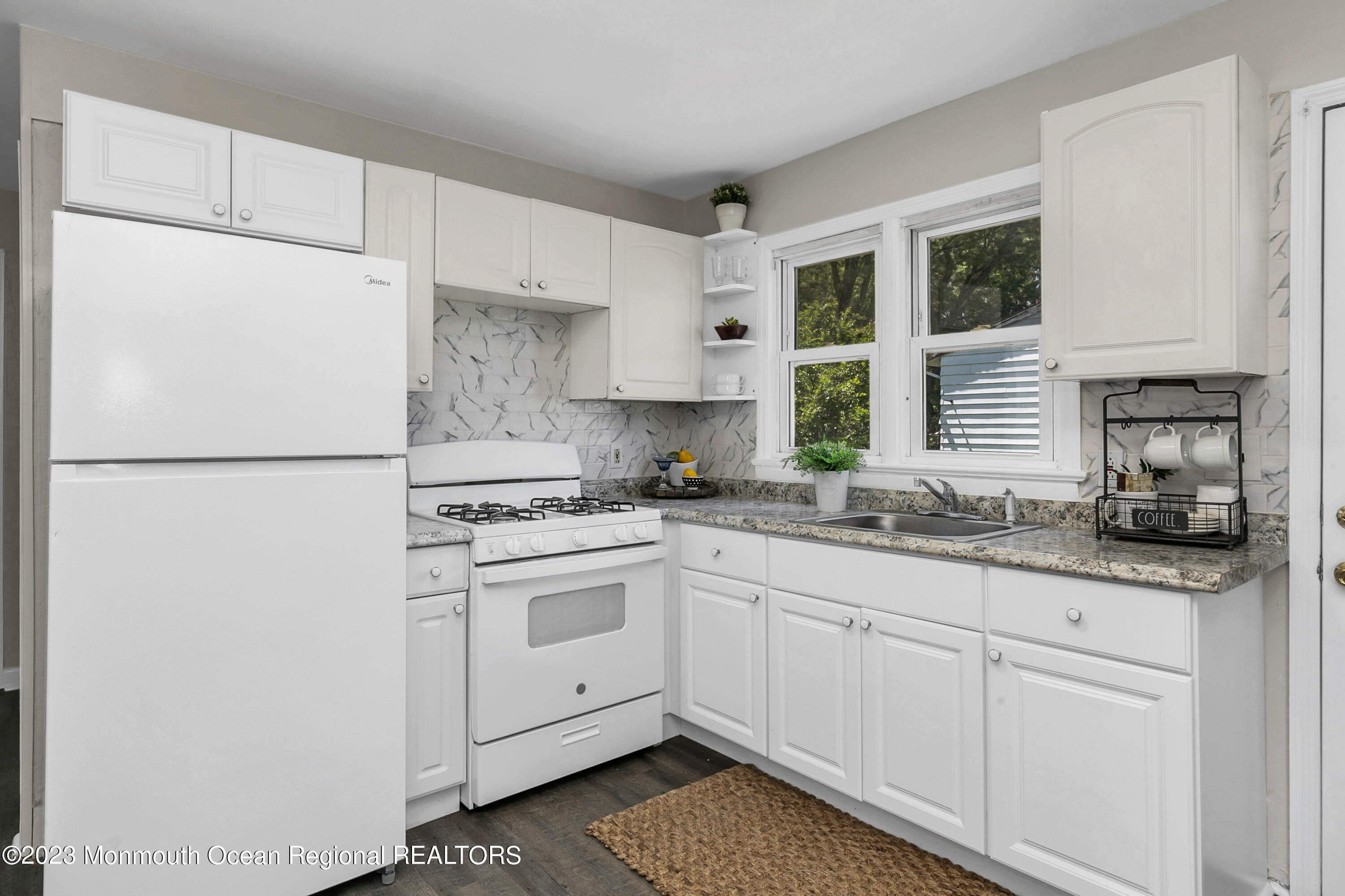197 Raritan Street Keyport, NJ 07735 - Photo 12 of 28 a kitchen with granite countertop a sink stainless steel appliances and white cabinets