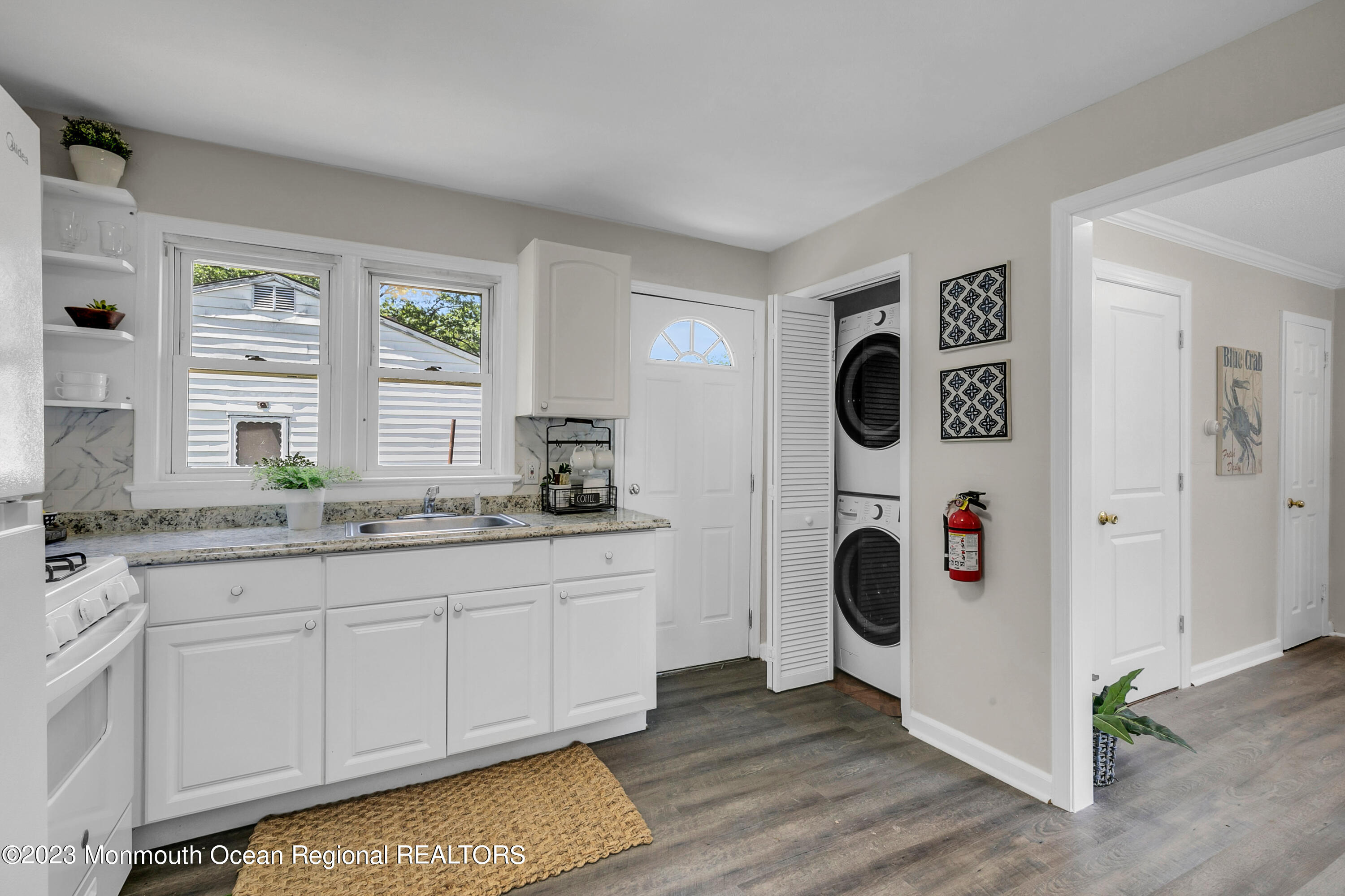 197 Raritan Street Keyport, NJ 07735 - Photo 14 of 28 a view of a kitchen with fridge and wooden floor