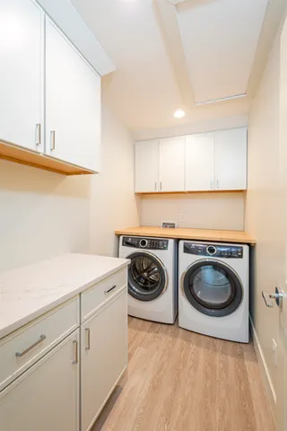 a utility room with sink dryer and washer