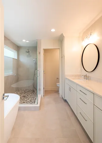 a bathroom with a granite countertop sink mirror and shower