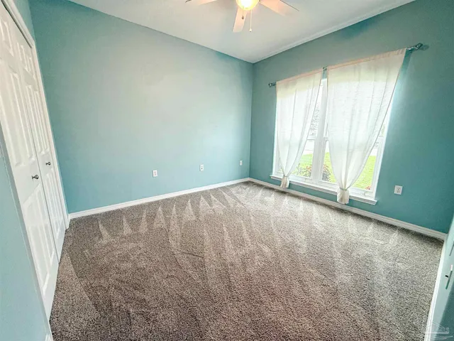 a park with water view and trees in the background