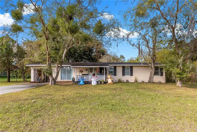a view of a house with backyard porch and sitting area