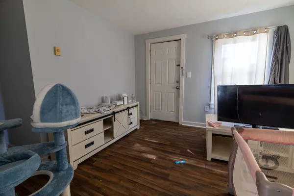 a kitchen with stainless steel appliances a stove a microwave and a hard wood floor