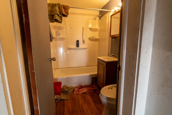 a bathroom with a shower toilet and sink