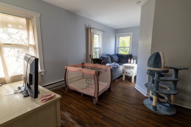 a kitchen with stainless steel appliances a stove a microwave and a hard wood floor