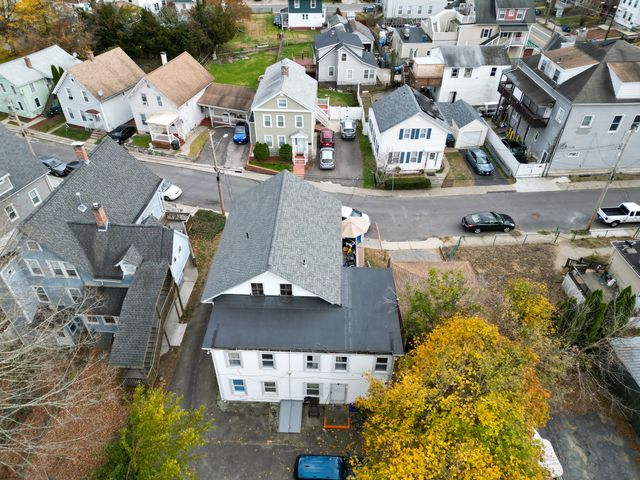 a car parked in front of a white house