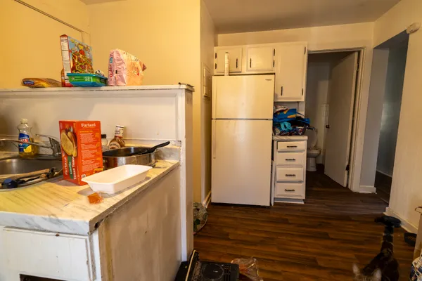 a kitchen with a refrigerator and a stove