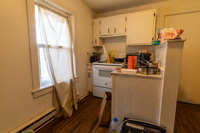 a kitchen with a refrigerator and a stove