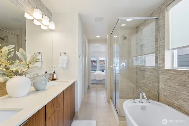 a bathroom with a double vanity sink mirror and shower