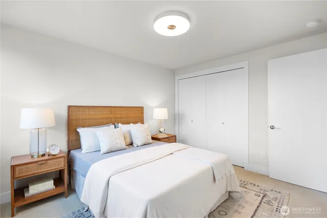 a bedroom with a bed and a lamp