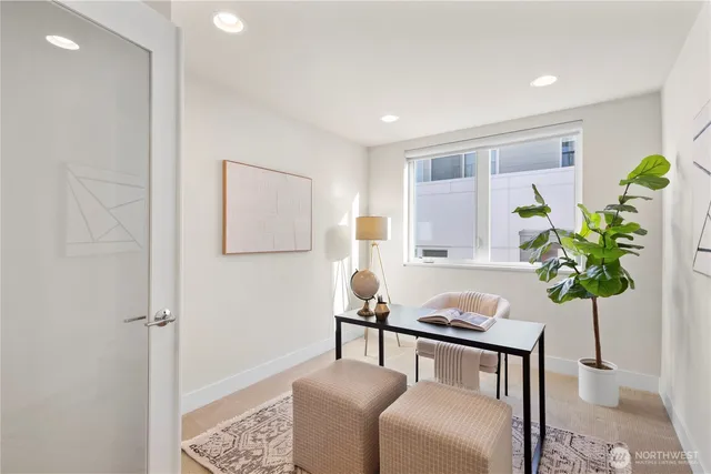 a living room with furniture and a potted plant