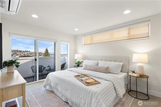 a bedroom with a large bed and a large window