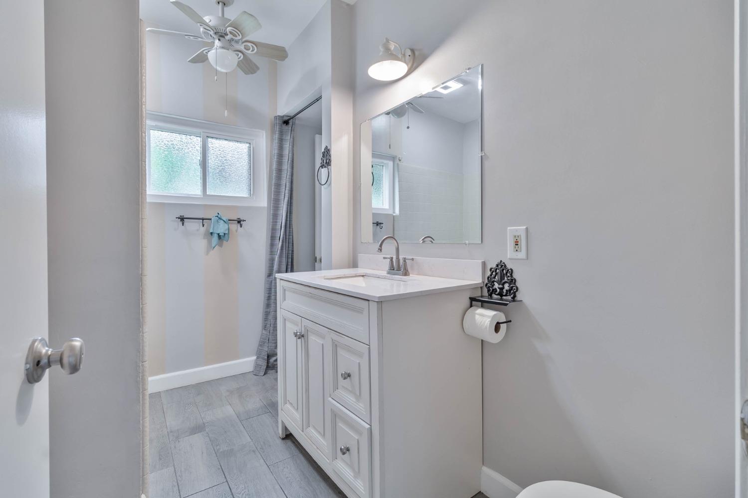 5856 East Park Cir Drive Fresno, CA 93727 - Photo 20 of 47 a bathroom with a double vanity sink mirror and toilet