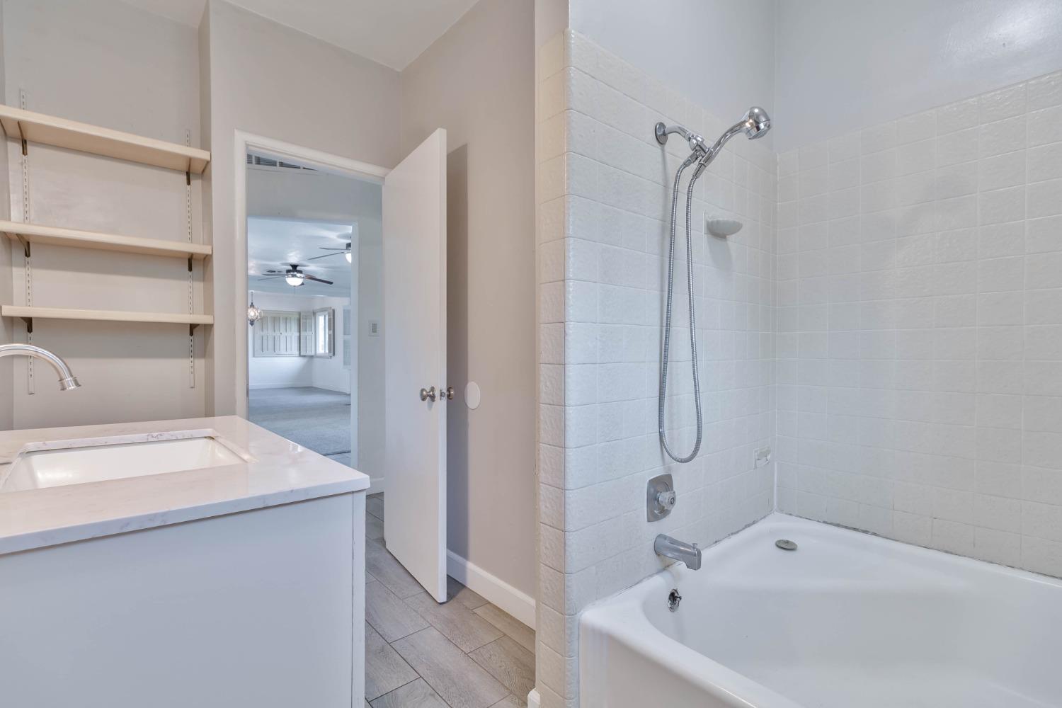 5856 East Park Cir Drive Fresno, CA 93727 - Photo 21 of 47 a bathroom with a sink and mirror