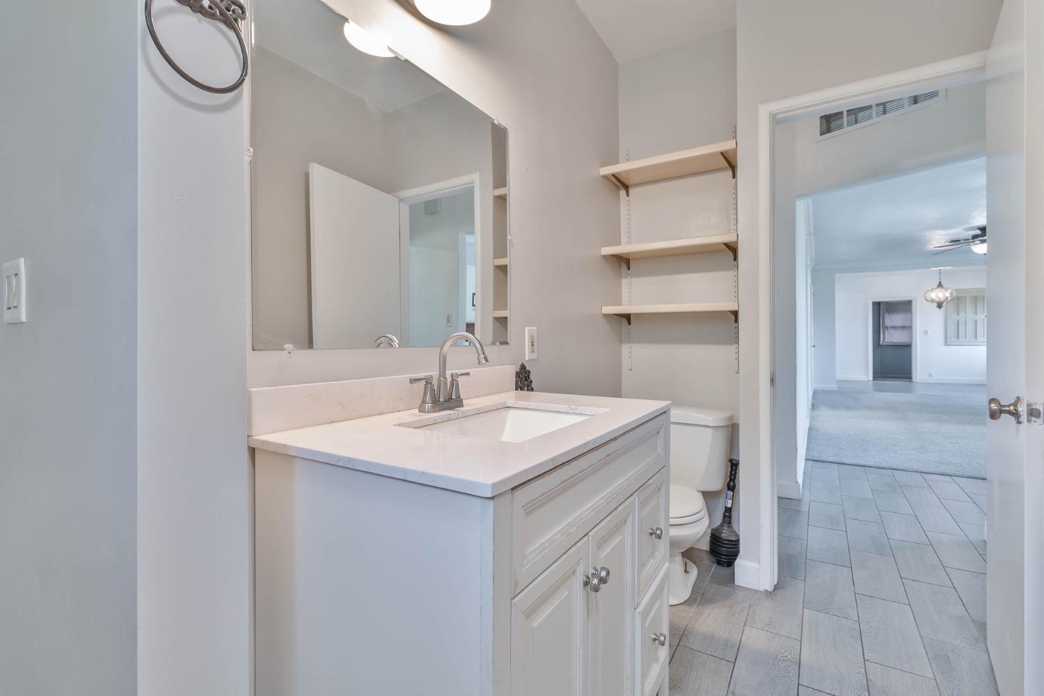 5856 East Park Cir Drive Fresno, CA 93727 - Photo 22 of 47 a bathroom with a sink a toilet and shower