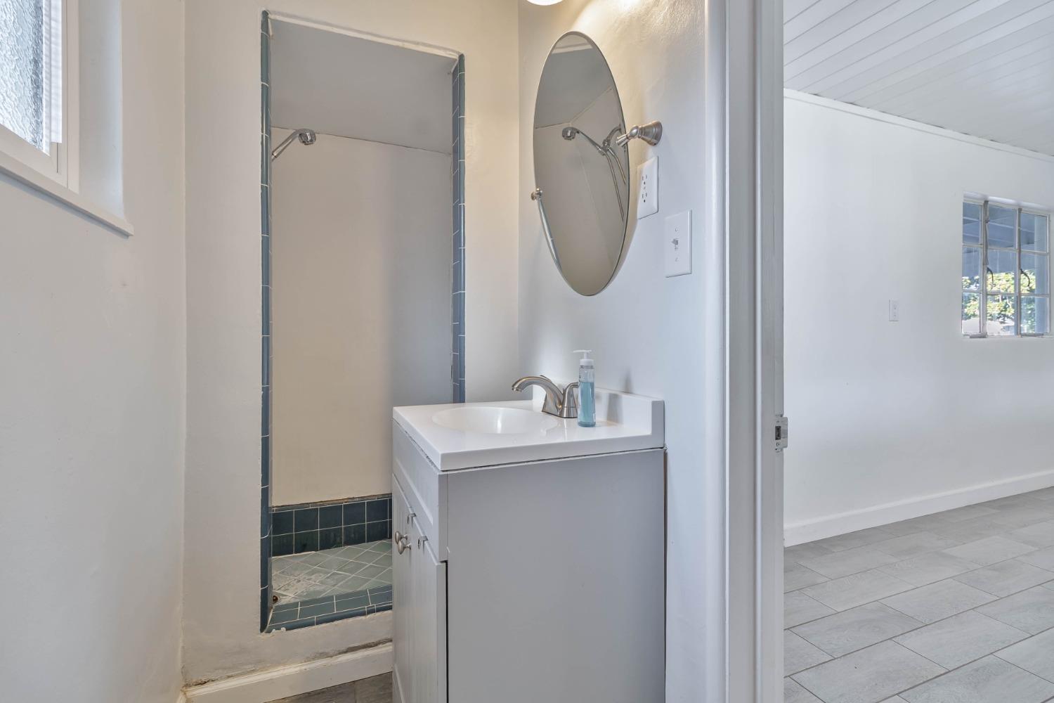 5856 East Park Cir Drive Fresno, CA 93727 - Photo 29 of 47 a bathroom with a sink and a mirror