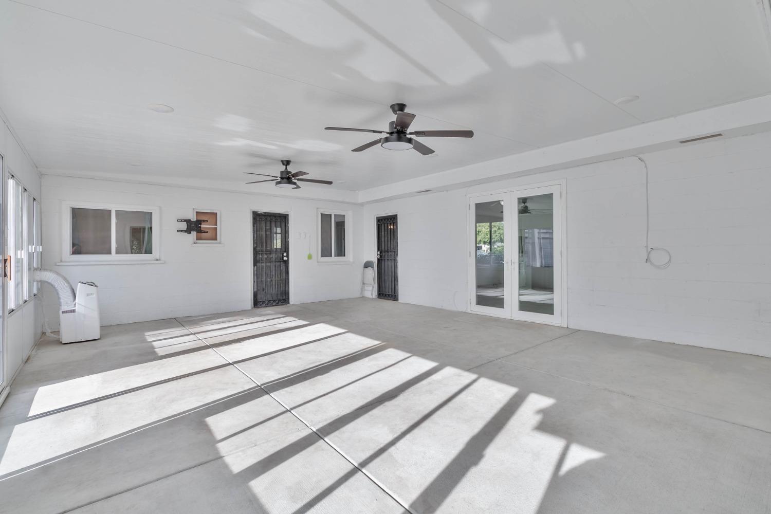 5856 East Park Cir Drive Fresno, CA 93727 - Photo 33 of 47 a spacious bedroom with a large bed and ceiling fan