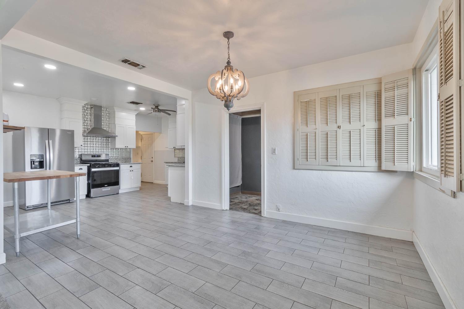 5856 East Park Cir Drive Fresno, CA 93727 - Photo 8 of 47 a view of a kitchen with an entryway and wooden floor