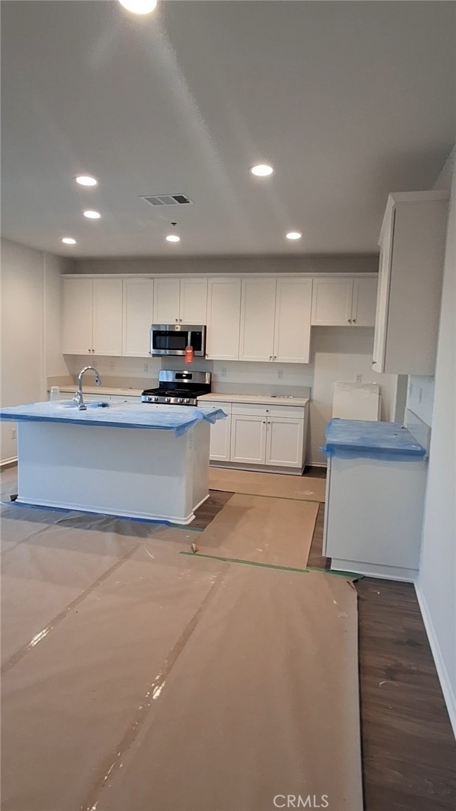 223 Oakton Court Hemet, CA 92543 - Photo 2 of 9 a kitchen with a sink stainless steel appliances and cabinets