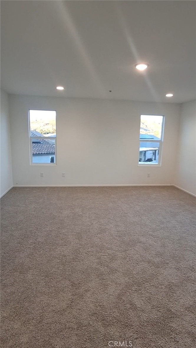 223 Oakton Court Hemet, CA 92543 - Photo 4 of 9 an empty room with windows and window