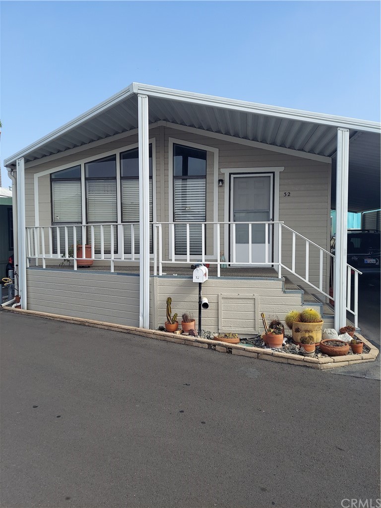 a front view of a house with glass windows and road