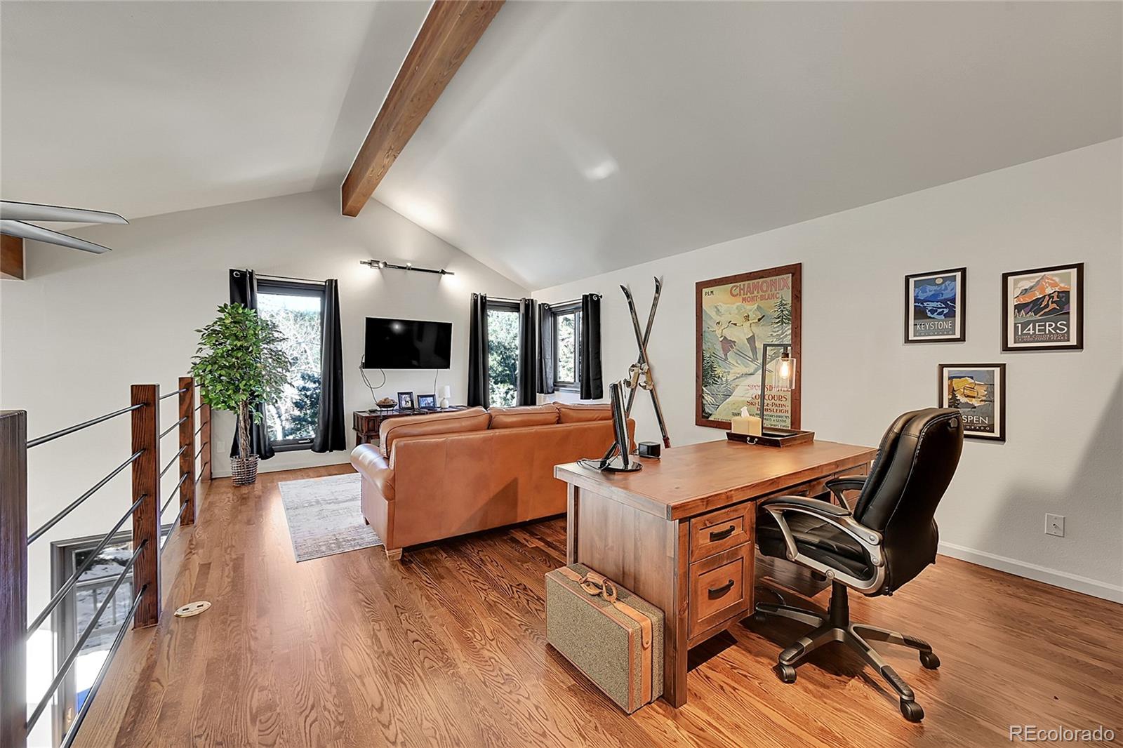 8959 South Hillview Road Morrison, CO 80465 - Photo 16 of 49 a view of a livingroom with furniture and a flat screen tv