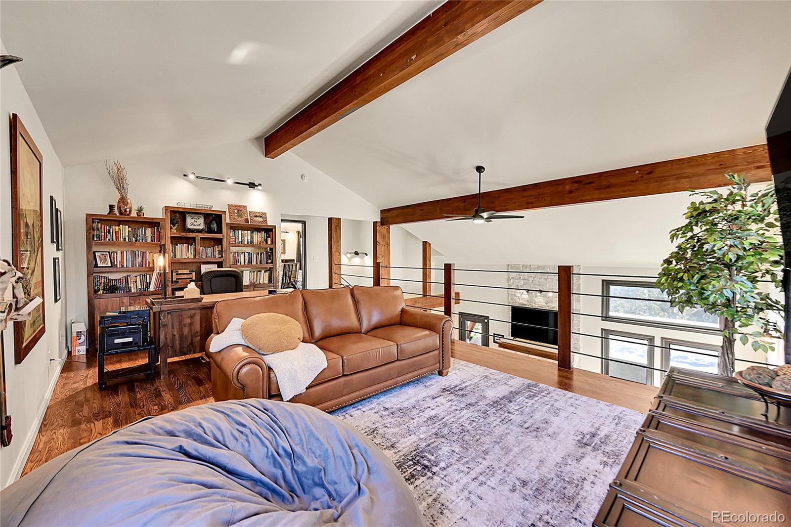 8959 South Hillview Road Morrison, CO 80465 - Photo 17 of 49 a living room with furniture a rug and a table
