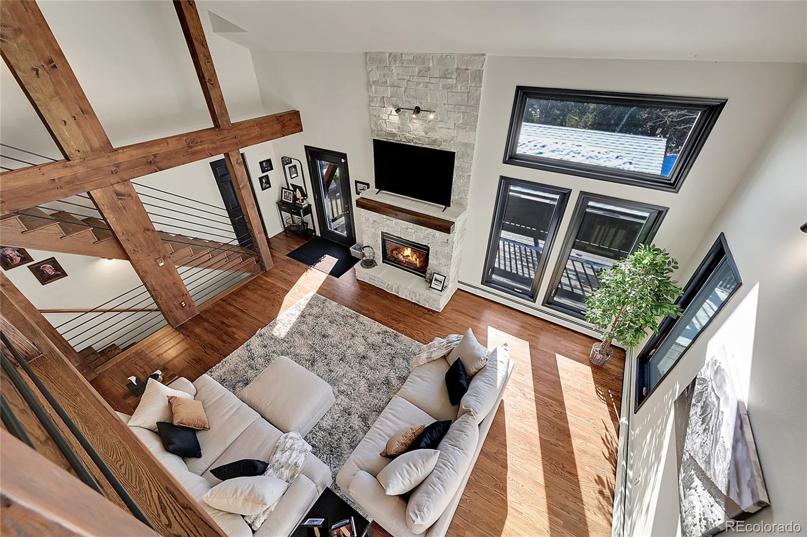 8959 South Hillview Road Morrison, CO 80465 - Photo 18 of 49 a living room with furniture and a flat screen tv