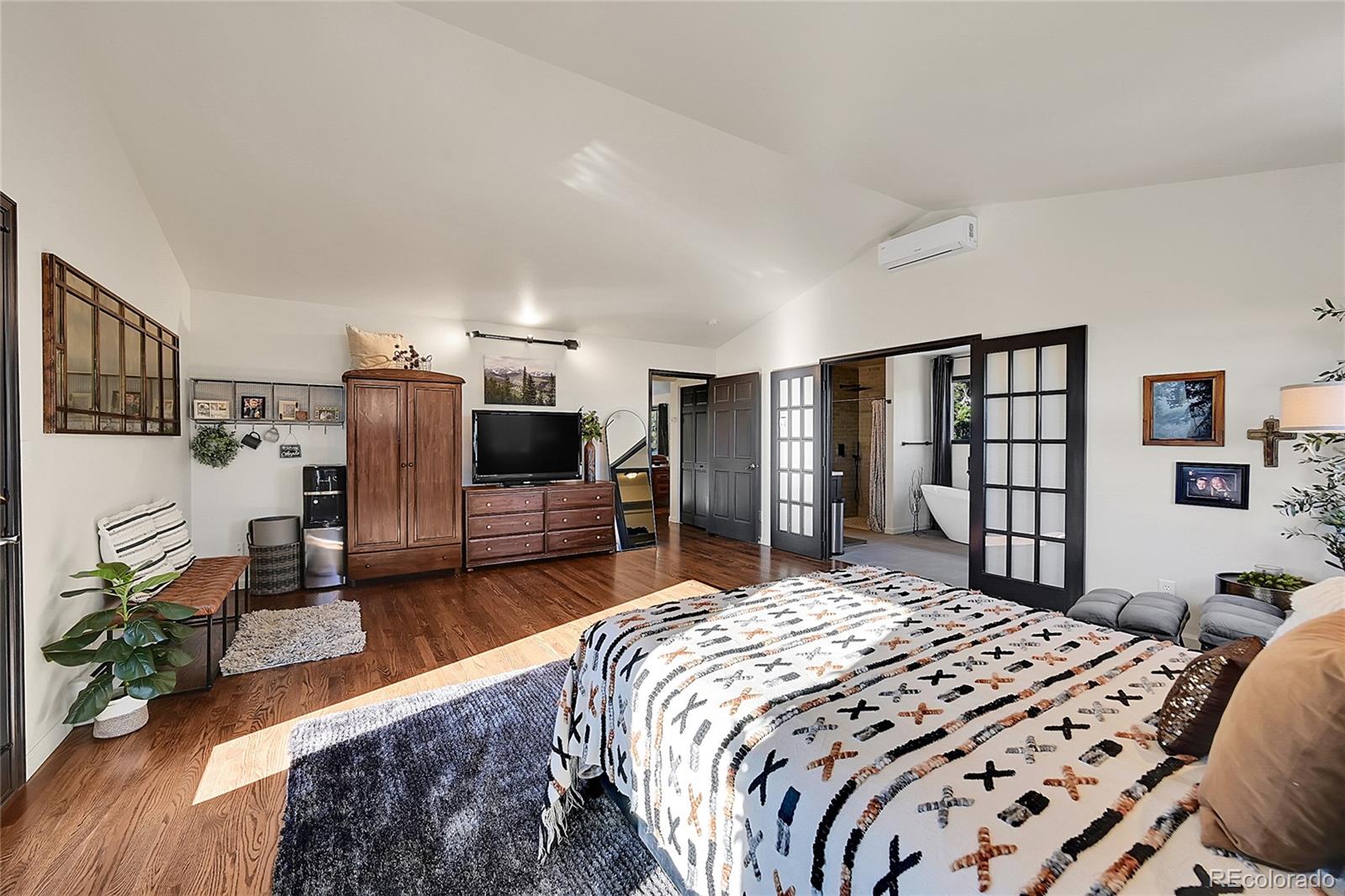 8959 South Hillview Road Morrison, CO 80465 - Photo 20 of 49 a bedroom with bed and a tv