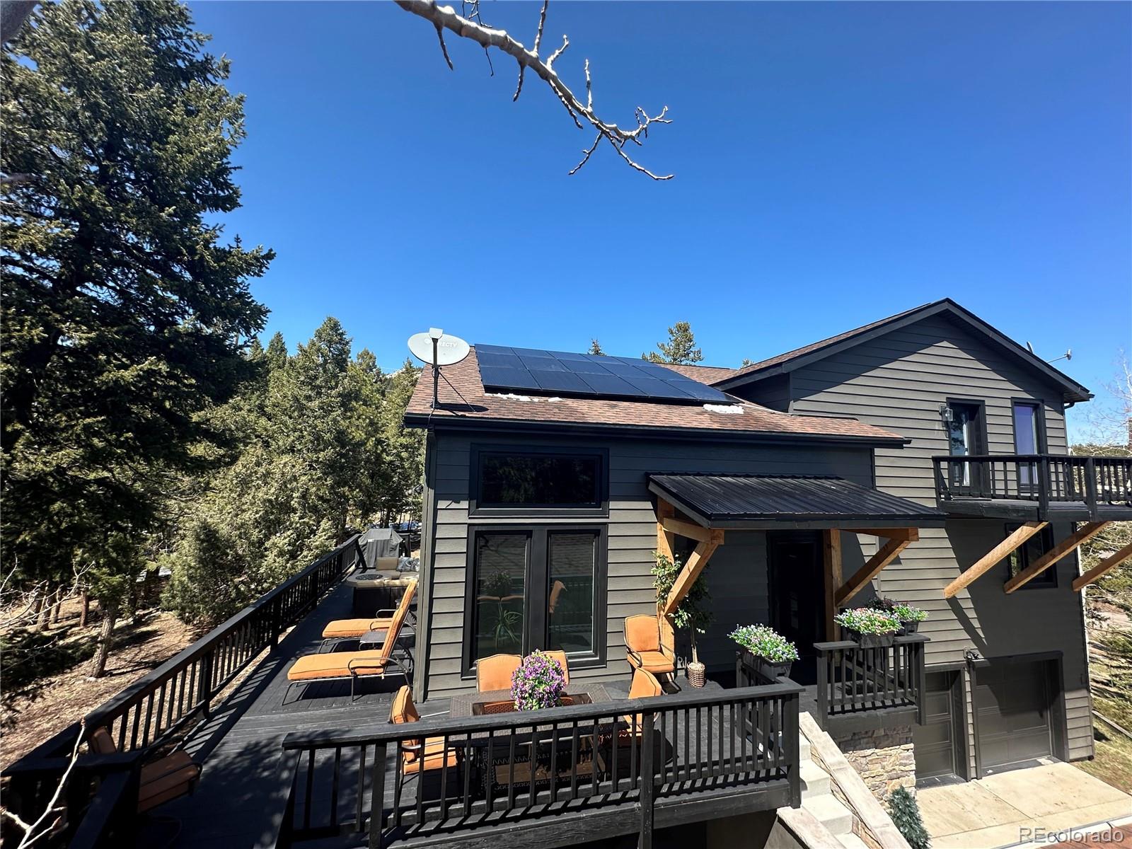 8959 South Hillview Road Morrison, CO 80465 - Photo 2 of 49 a view of house with deck and outdoor seating