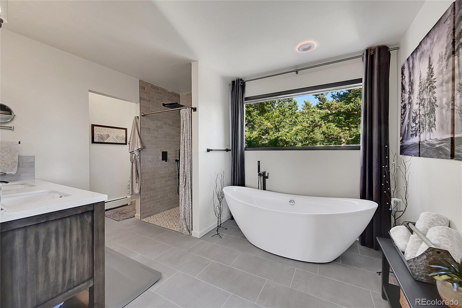 8959 South Hillview Road Morrison, CO 80465 - Photo 21 of 49 a bathroom with a tub a sink and a large mirror