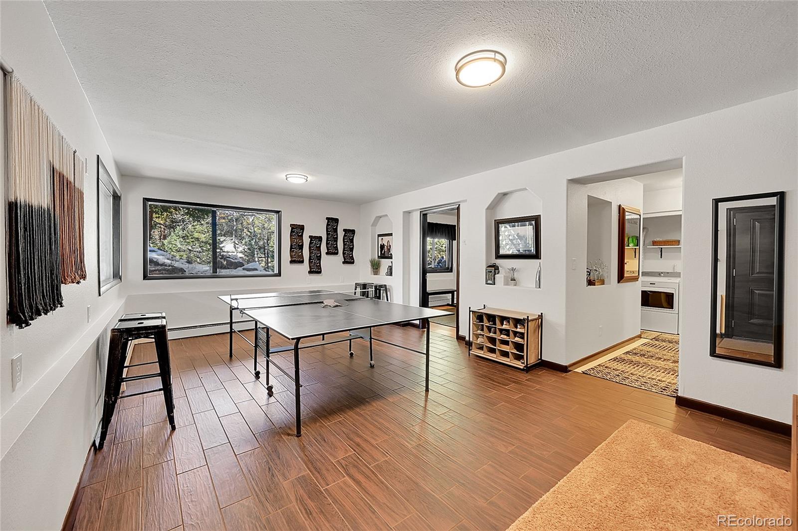 8959 South Hillview Road Morrison, CO 80465 - Photo 26 of 49 a living room with furniture and a flat screen tv